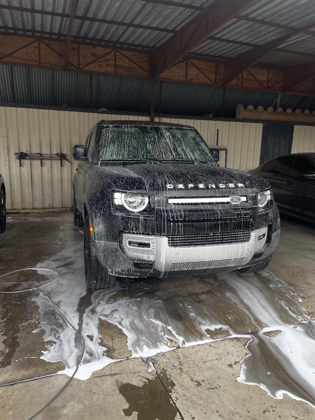 Land Rover Defender covered in foam during a wash